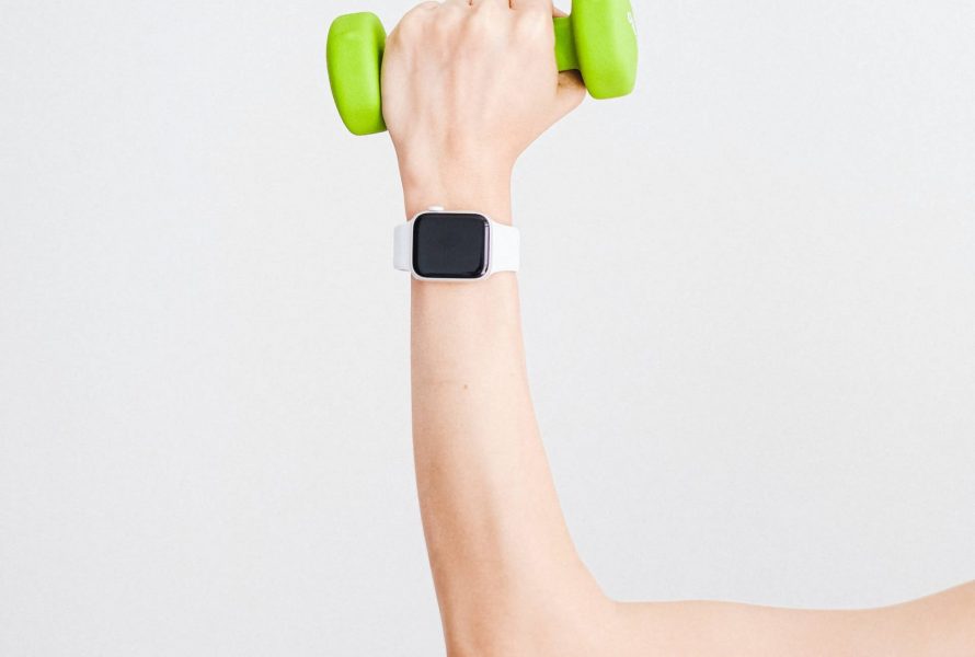 person-wearing-white-apple-watch-while-holding-green-4482936