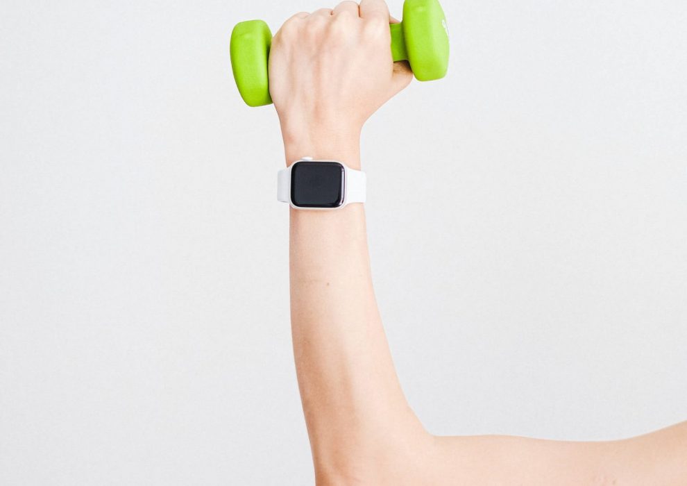 person-wearing-white-apple-watch-while-holding-green-4482936