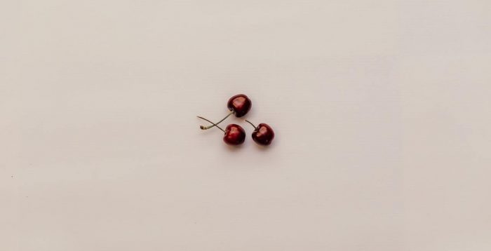 three-red-cherry-fruits-on-white-surface-1215854